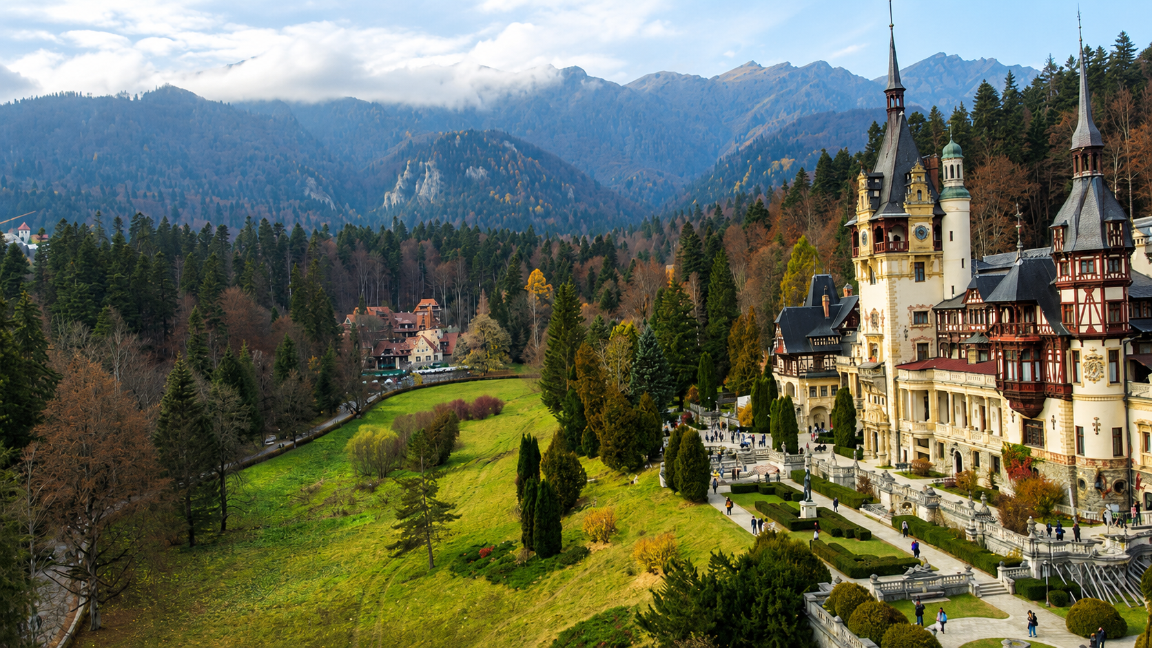 The terraced gardens and wooded grounds below Peleș Castle in Sinaia, Romania.