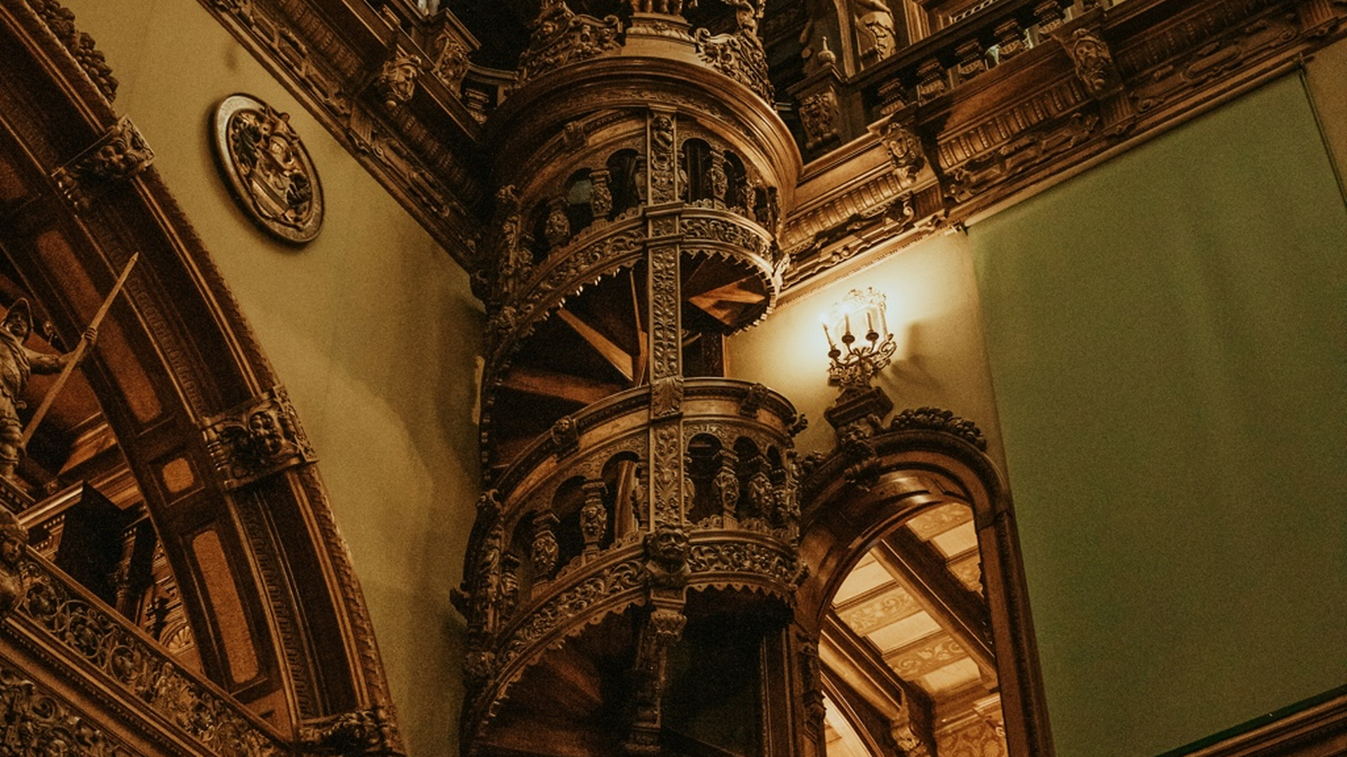 The ornate interior of Peleș Castle — carved walnut panelling, stained glass and gilded ceilings in the State Rooms